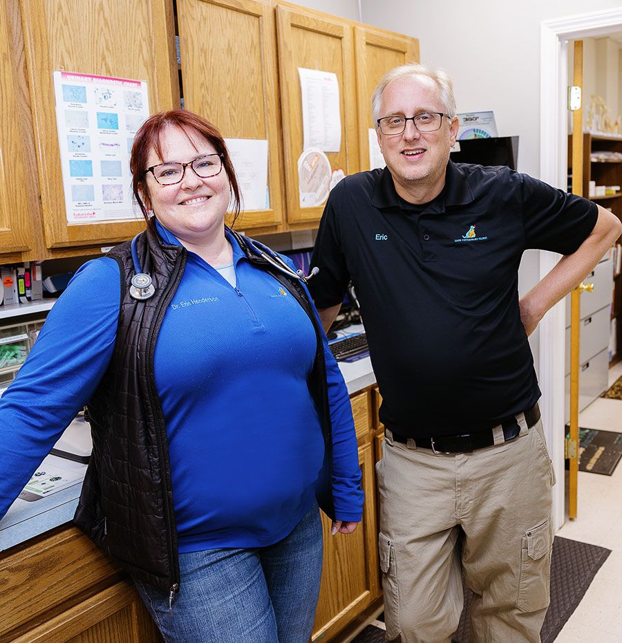 A woman and a man standing next to each other in an office kitchen.
